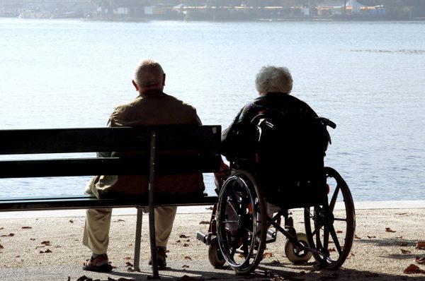 Una parella d'ancians asseguda, mirant el mar
